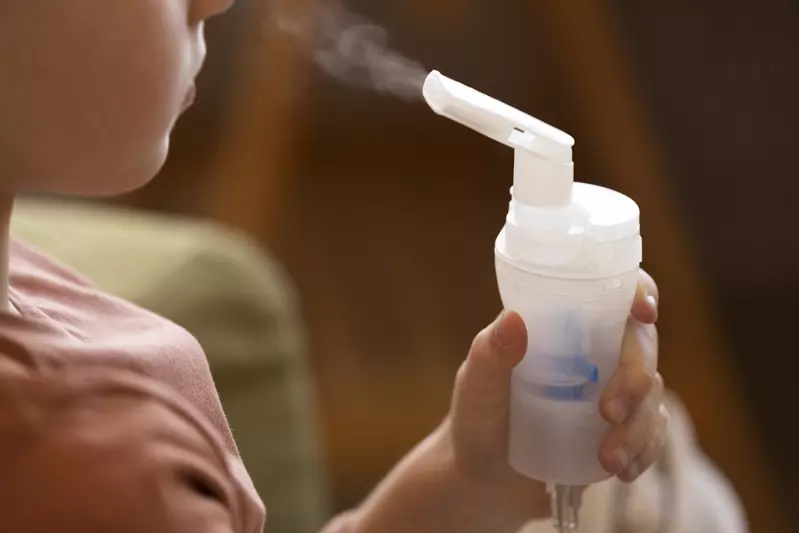 girl using nebulizer