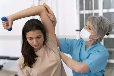 medical assistant helping patient 